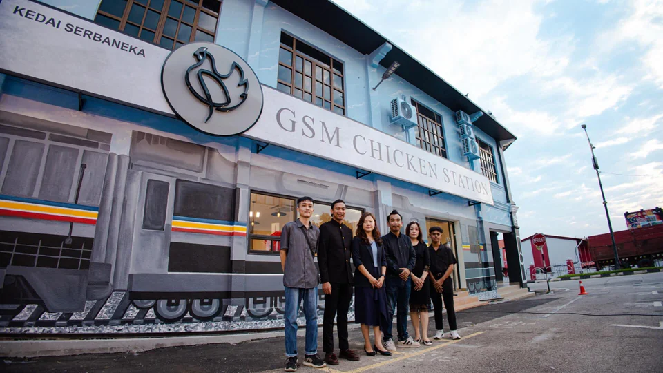 The GSM Chicken Station team in front of the train-themed store